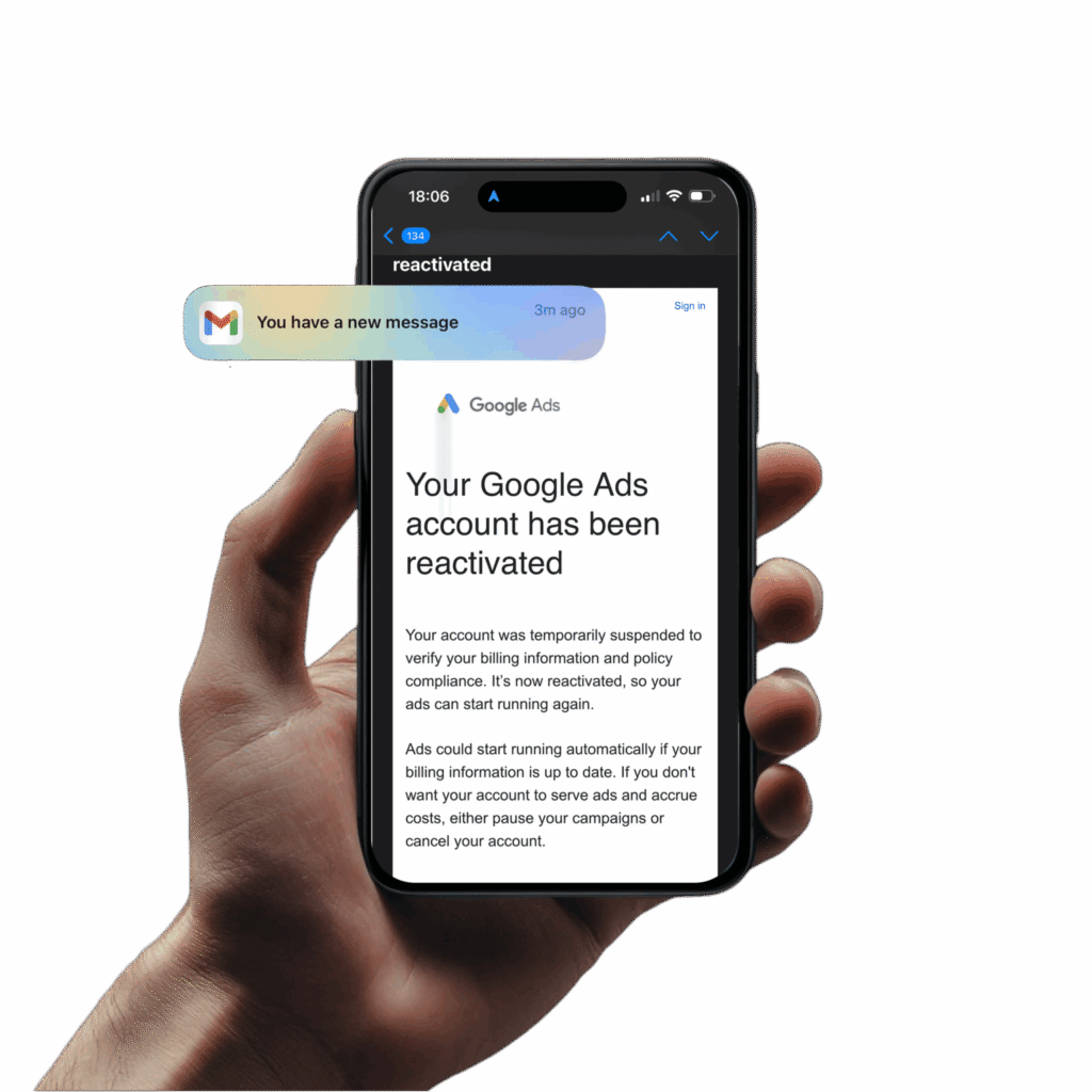 Hand holding a phone showing a Google Ads account reactivation notification